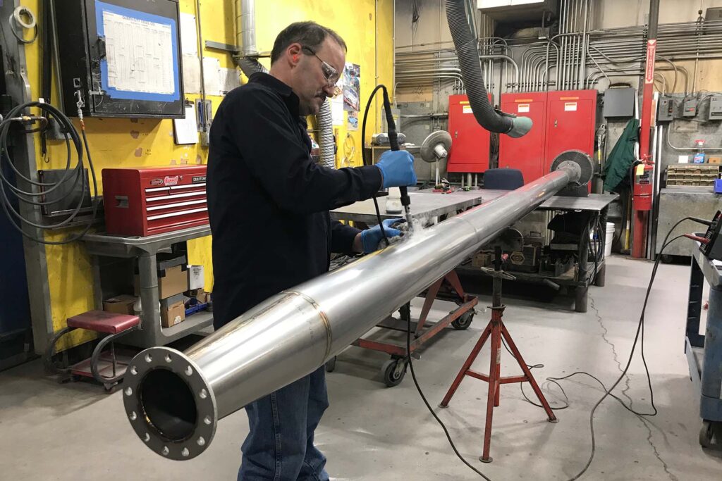 Man working on MRI Quench Vent