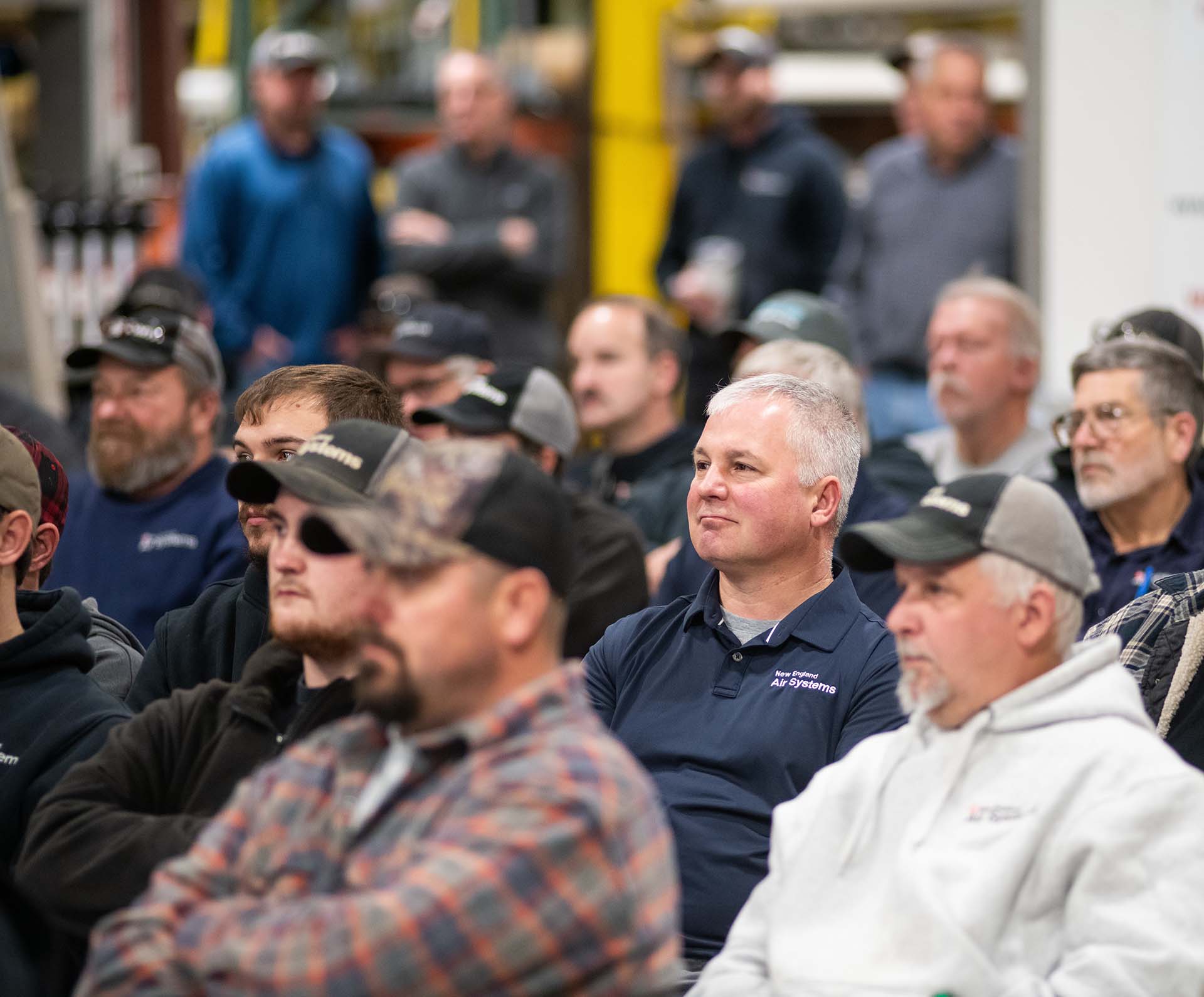 a group of NE Air employees sitting down at a training for safety day