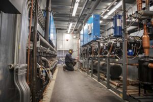 worker performing service on specialty refrigeration system