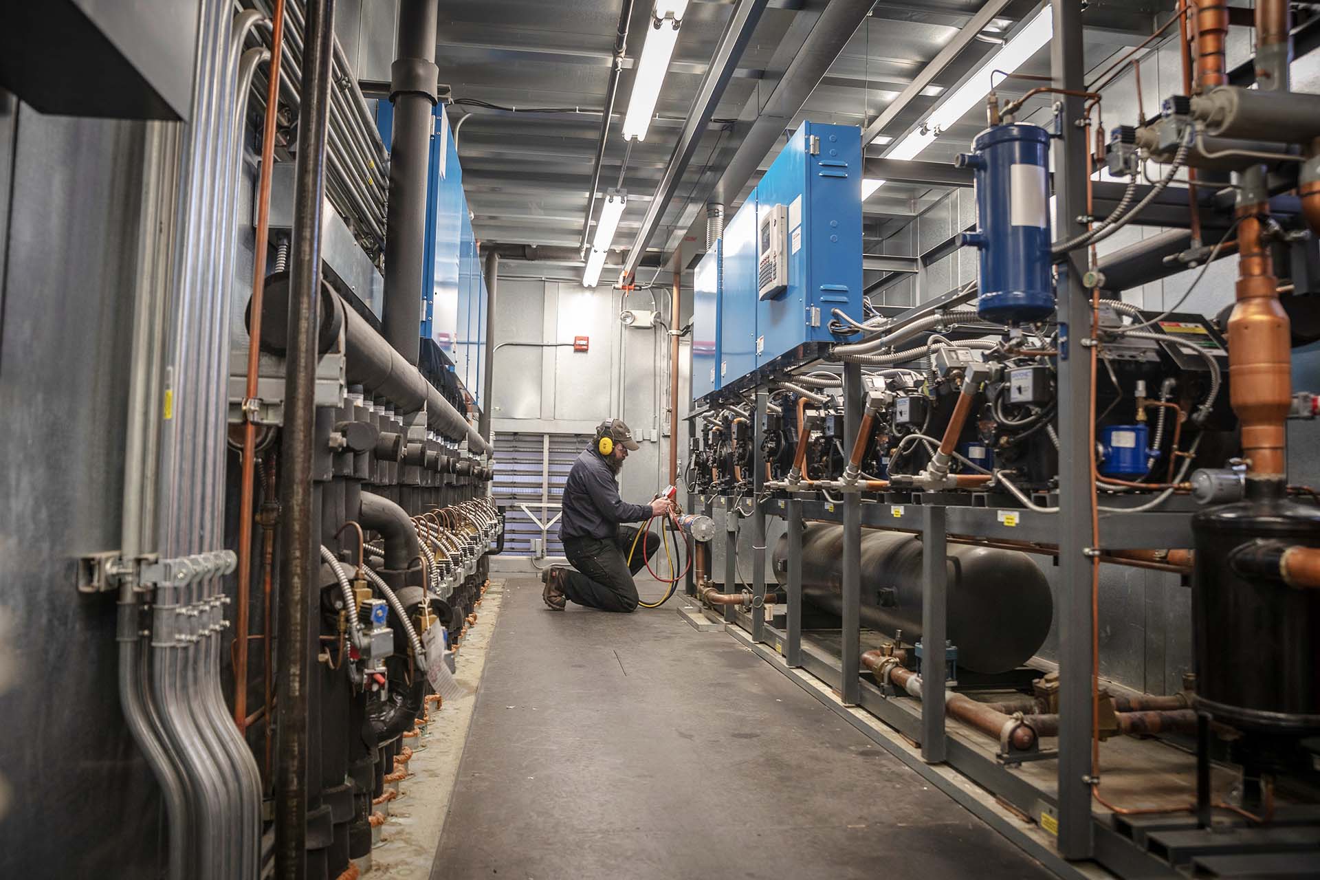 worker performing service on specialty refrigeration system