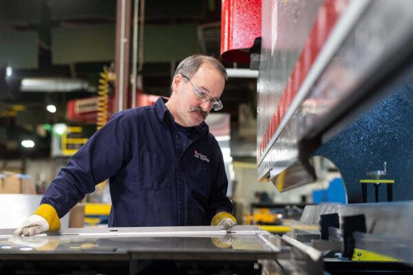 Worker at press brake
