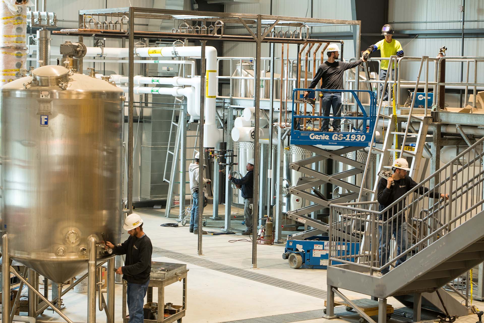 NE air workers servicing an HVAC system in a warehouse