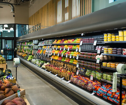 refrigerated display cases filled with produce at Healthy Living