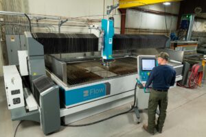 employee working at Mach500 waterjet machine