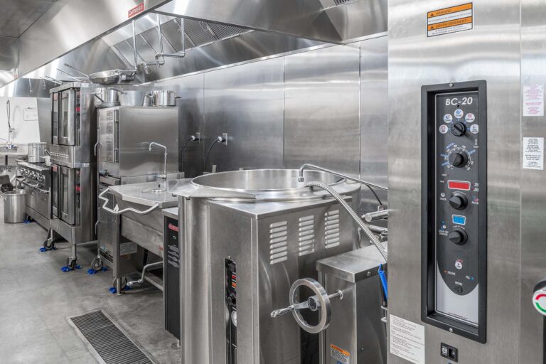 stainless steel appliances and wall panels in commercial kitchen