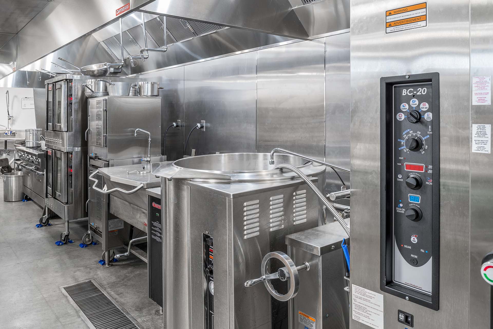 stainless steel appliances and wall panels in commercial kitchen