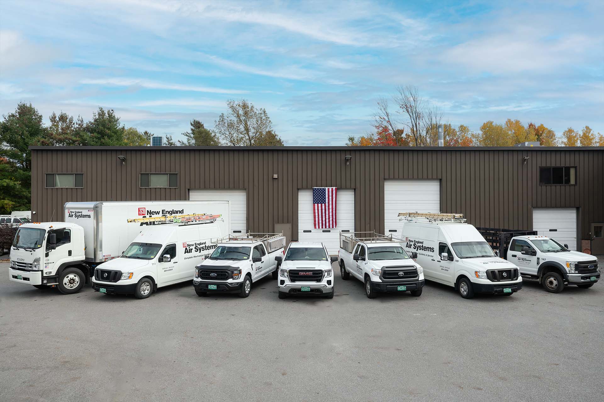 NE Air vehicle fleet lined up in front of warehouse